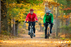 a person riding a bike down a dirt road