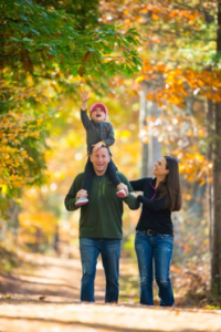 a person standing next to a tree