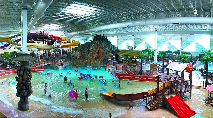 Large indoor waterpark with slides and tropical scenery