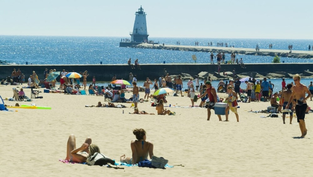 a group of people sitting at a beach